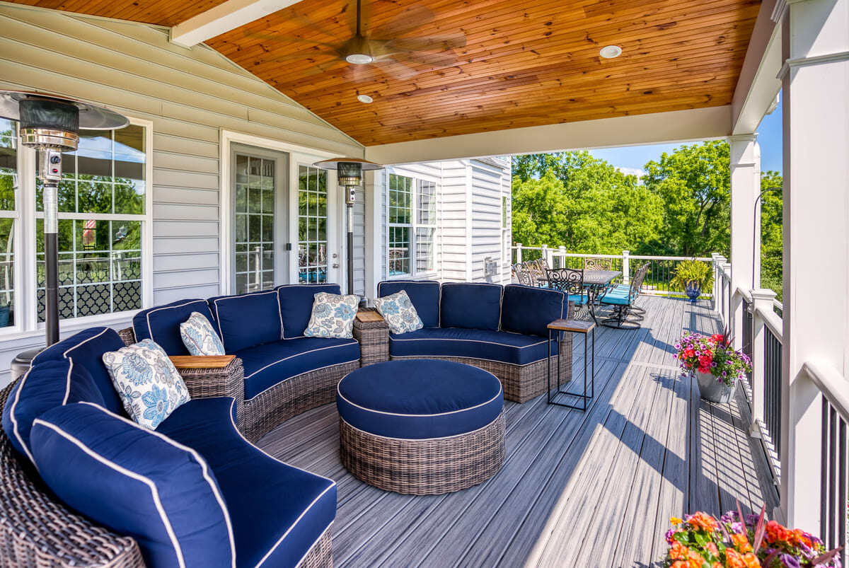 Open porch with gable roof and ceiling fan by Deckscapes of VA