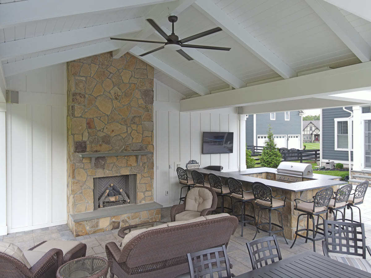 Natural veneer on fireplace and outdoor kitchen in Northern VA pool house