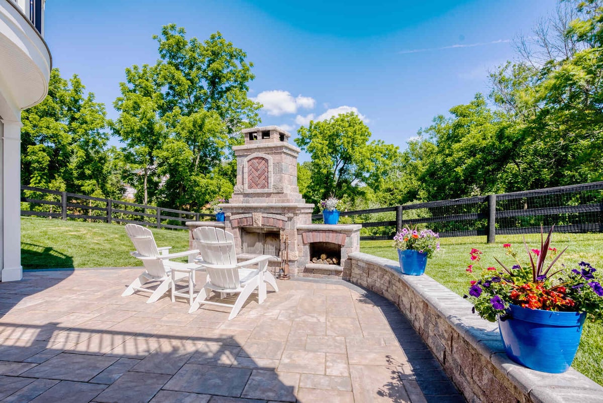 Cozy patio with fireplace and scenic view, crafted by Deckscapes of Virginia