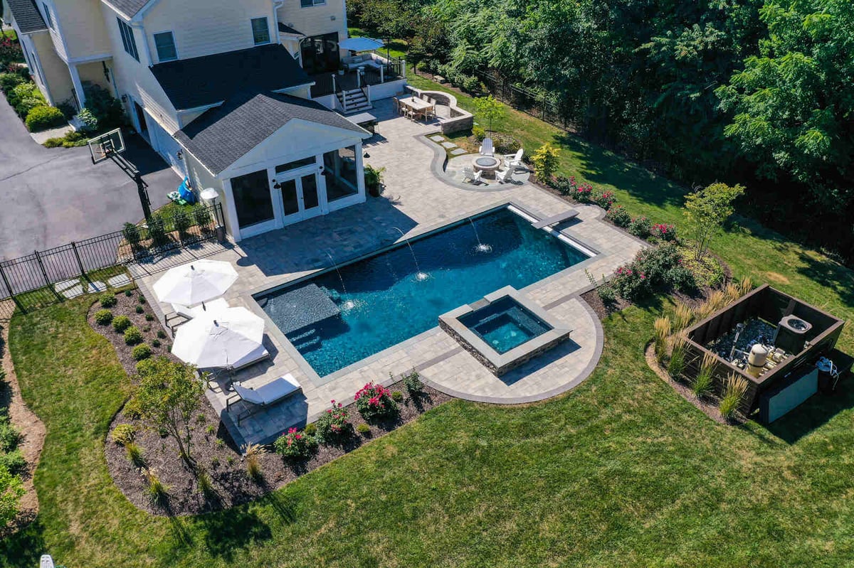 aerial backyard with inground pool waterfall hot tub and pavilion (1)